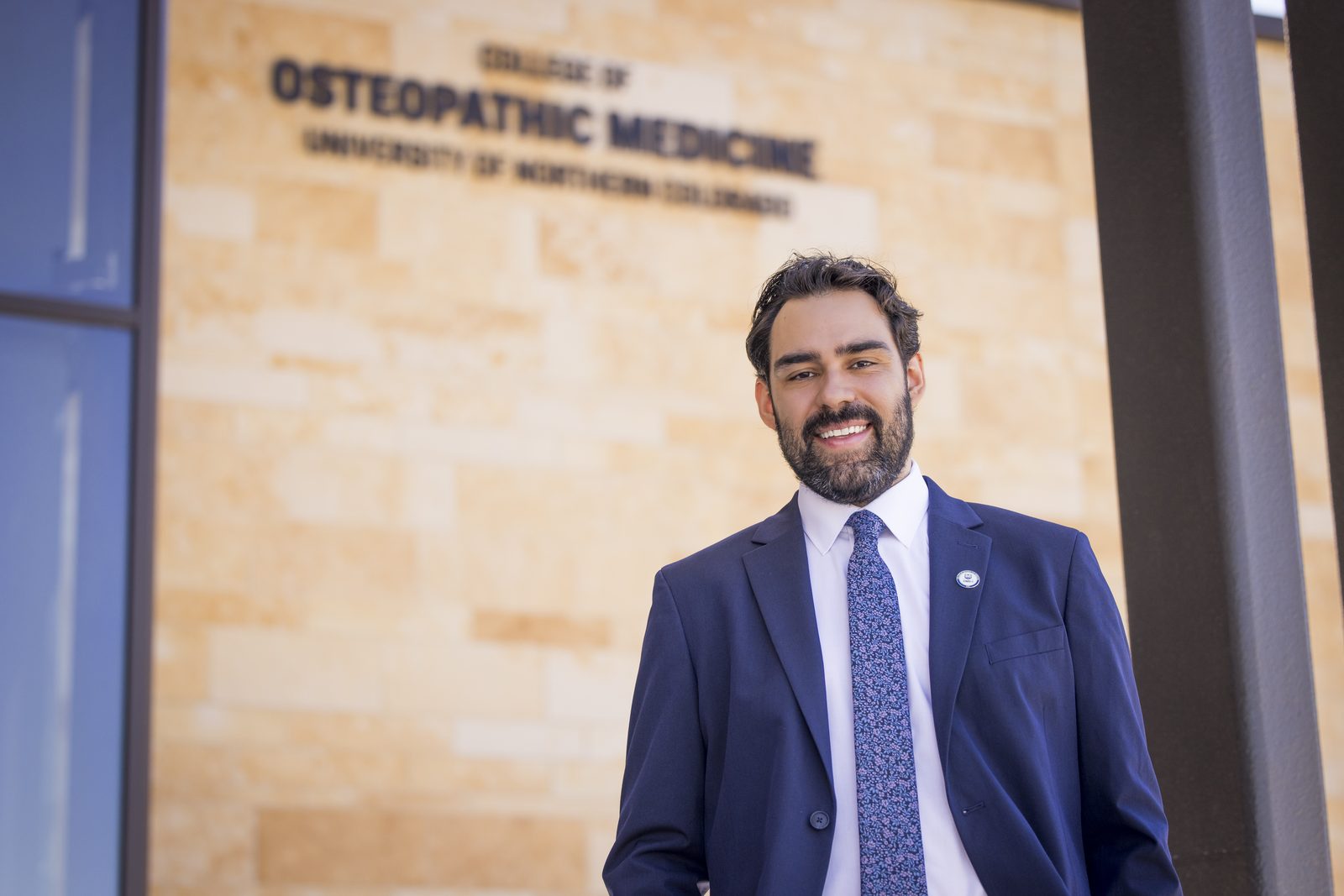 Eric in front of the College of Osteopathic Medicine sign at UNC